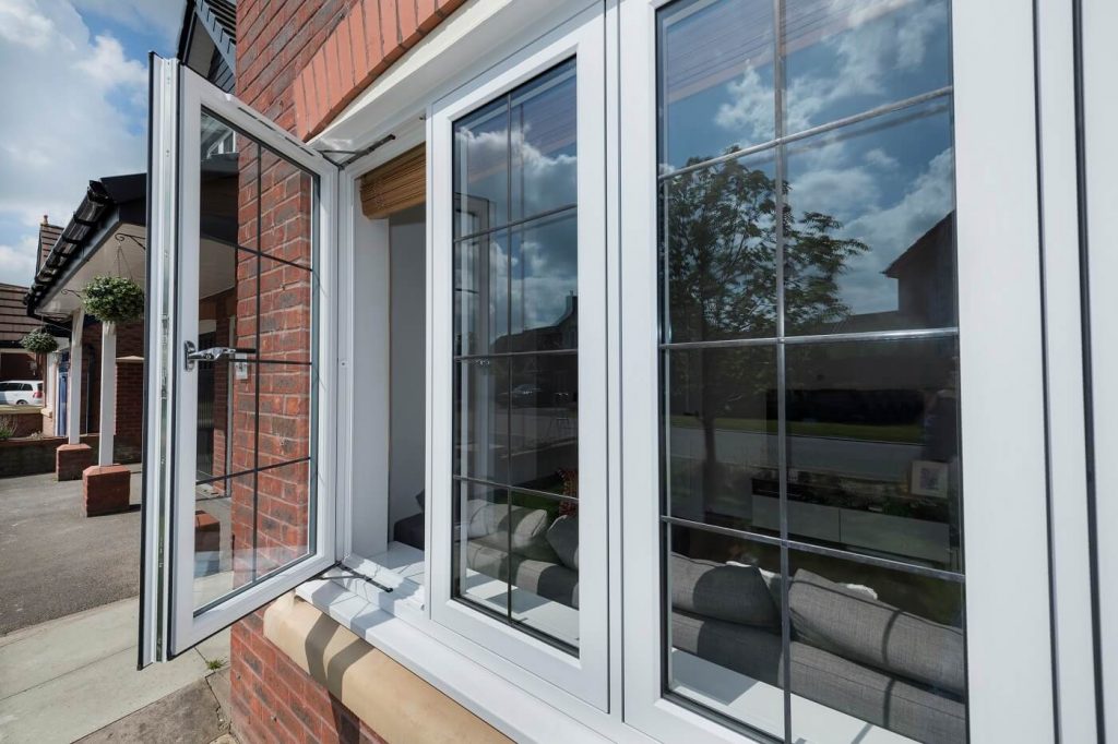 White flush casement windows with leaded glass