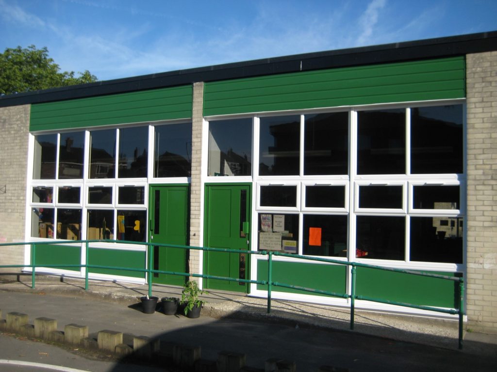 White uPVC windows and bespoke green aluminium commercial doors