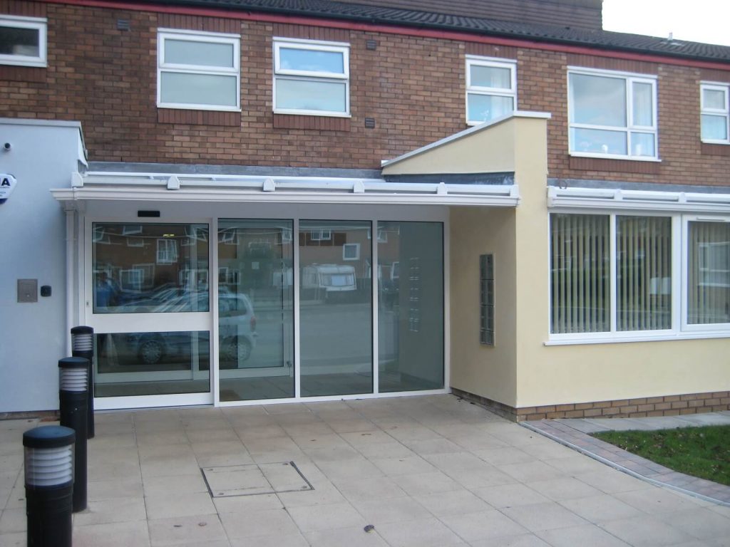 White glazed aluminium doors with automated controls