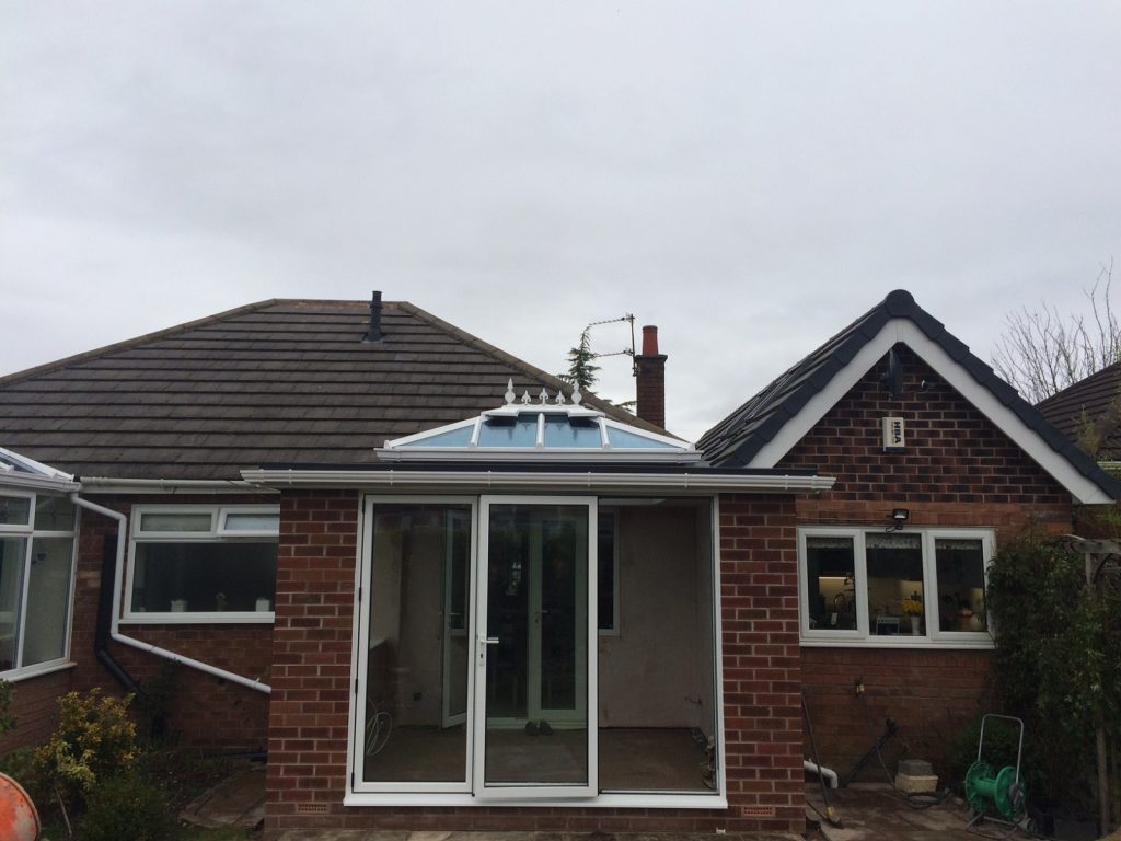 White lantern roof orangery with aluminium bifold doors