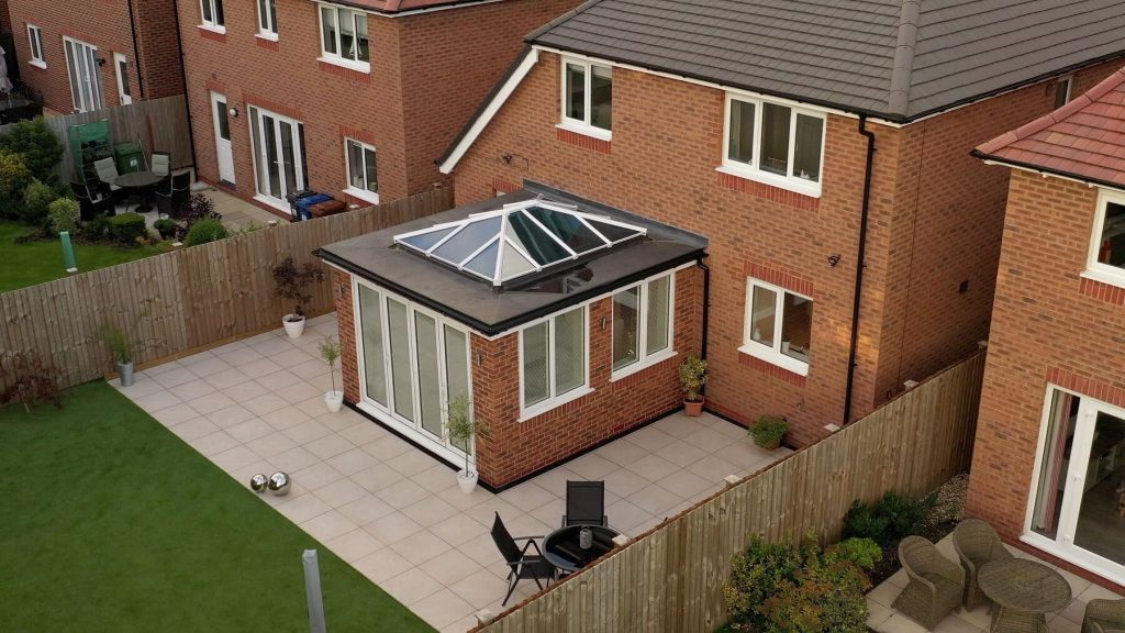 Modern orangery with white lantern roof and bifold doors