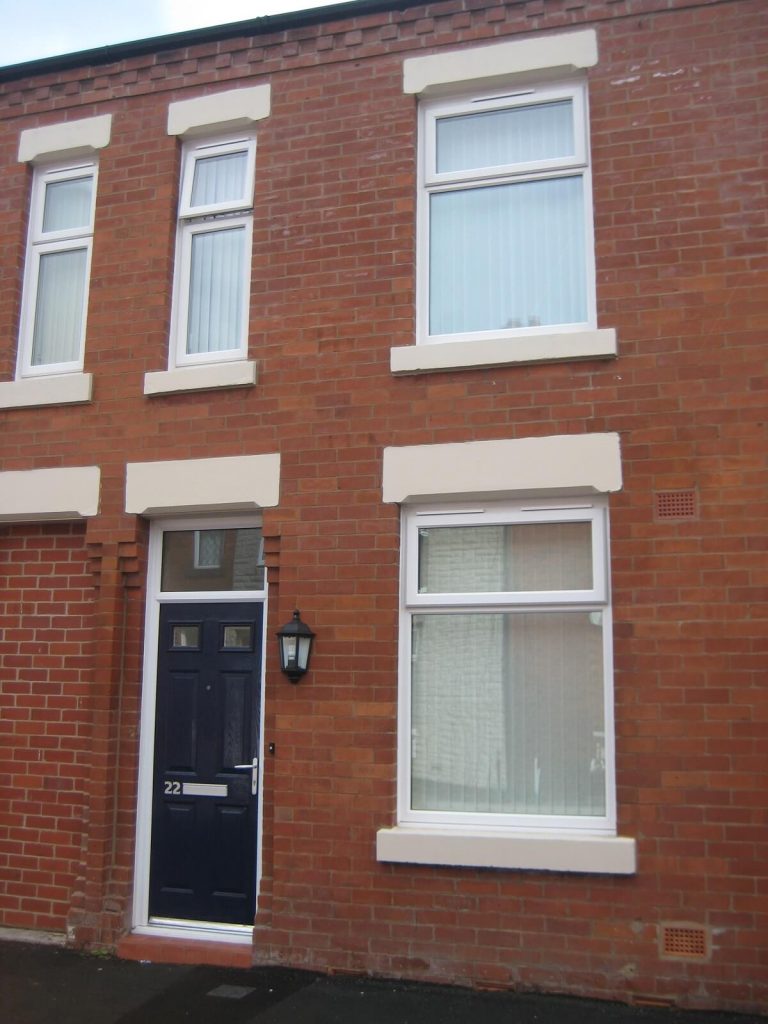 White uPVC windows and composite door with toplight