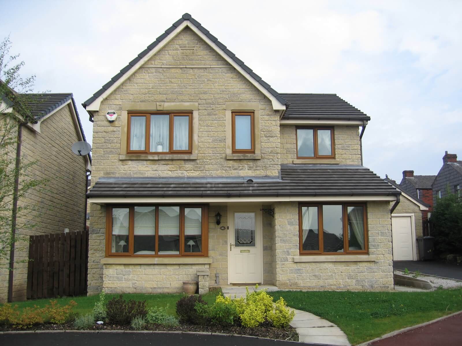 Golden oak uPVC windows installed in Bolton
